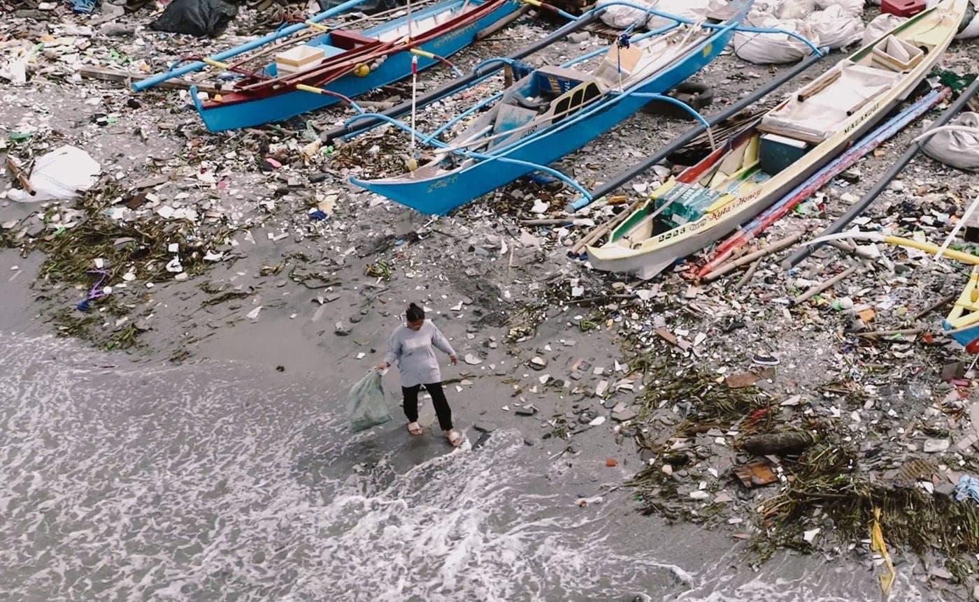 Fishing boats and plastic on a shoreline in the Philippines