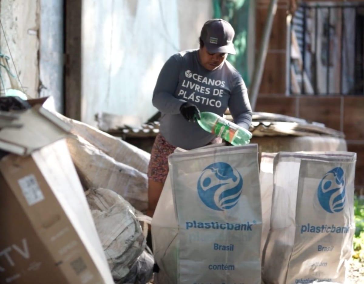 A collector in Brazil sorting plastic into Plastic Bank sacks