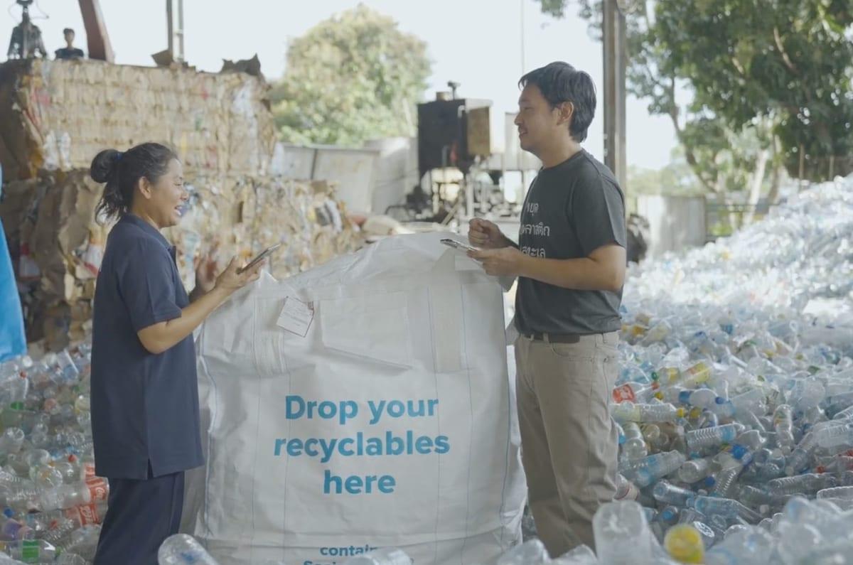 Plastic Bank staff with a drop-off bag at a collection point in Thailand