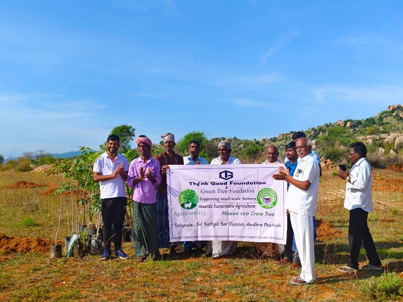 A community group holding a banner at a fruit tree planting in Andhra Pradesh, India