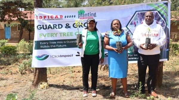 COPICAD team holding seedlings at a Guard & Grow tree planting in Kenya